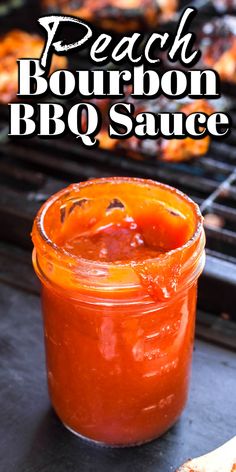 peach bourbon bbq sauce in a glass jar next to grilled hotdogs