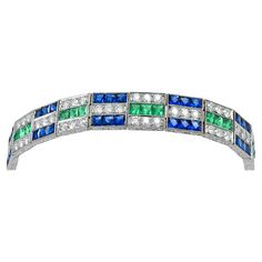 Art Deco inspired bracelet set in platinum that features a 4.16 carats of green emerald, 4.25 carats of diamond, 10.82 carats of blue sapphire. Sophia D has been known world-wide for over 40 years because of its rich history of design and quality craftsmanship. From art deco to antique reproduction, these timeless pieces, when merged with modern manufacturing techniques, create a perfect harmony between old and new Green Art Deco Jewelry With Diamond Accents, Green Art Deco Bracelets As A Gift, Green Art Deco Bracelets As Gift, Green Art Deco Bracelet, Art Deco Sapphire Jewelry Hallmarked, Gems Bracelet, Art Deco Bracelet, Inspiration Art, Green Jewelry