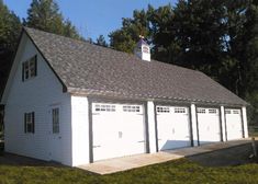 a two car garage is shown in front of some trees