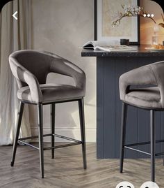 two grey velvet bar stools in front of a counter