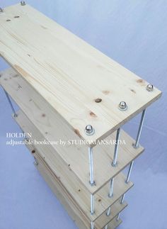 a wooden table with nails and screws attached to the top, on a blue background