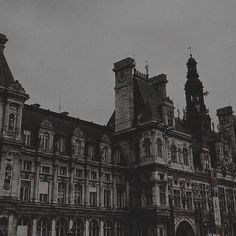 an old building with two clocks on the top of it's towers and steeples