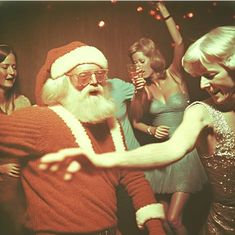 a man dressed as santa claus dancing with other people