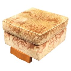 a square footstool with an intricate design on it's top and wooden legs