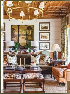 a living room filled with lots of furniture and paintings on the wall above it's windows