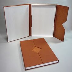 an open book with a hole in the middle and two pages missing from it on a white surface