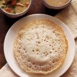 two bowls of soup and some bread on a table