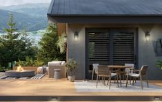 an outdoor dining area with chairs, table and fire pit in the middle of it