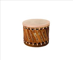 a small wooden drum sitting on top of a white surface