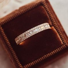 a diamond ring sitting in a velvet box