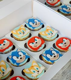 cupcakes with cartoon characters are in a box