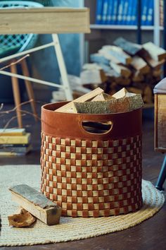 a basket that is sitting on the floor next to some kind of hammers and wood