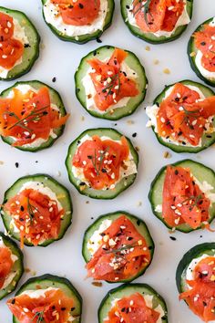 cucumbers with smoked salmon and cream cheese on them are ready to be eaten