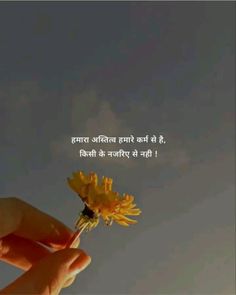 a person holding a flower in their hand with the sky behind them and an inscription on it