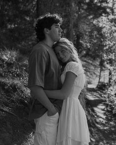 black and white photograph of a couple embracing in the woods