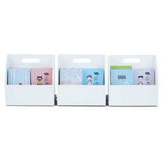 three white bins with books in them