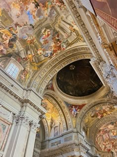 the interior of a church with paintings on the ceiling