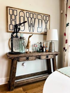 a wooden table with bottles on it in front of a sign that says, hollywood