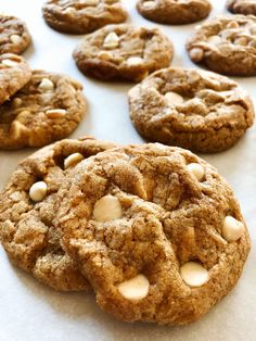 cookies with white chocolate chips are on a baking sheet