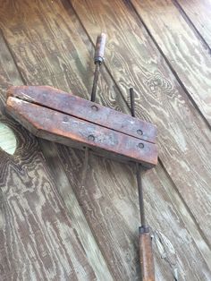 an old wooden tool laying on top of a wooden floor