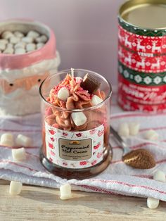 a jar filled with candy and marshmallows on top of a table