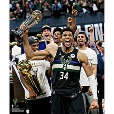 the milwaukee bucks celebrate with their trophy after winning the eastern conference