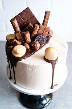 a white cake with chocolate and cookies on top