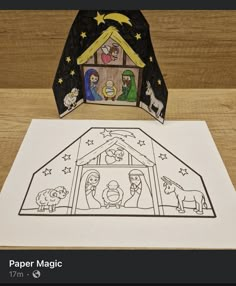 a nativity scene made out of paper on top of a table