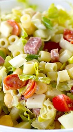 a bowl filled with pasta salad on top of a table