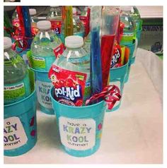 several buckets filled with water and toothbrushes sitting on a table next to each other