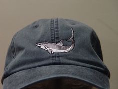 NEW EMBROIDERED MAKO SHARK MARINE WILDLIFE HAT (HATS PICTURED ARE NAVY BLUE, PERIWINKLE BLUE, BURGUNDY, CHARCOAL, CARIBBEAN BLUE, OLIVE GREEN AND BLACK) Adams Optimum 6 Panel Baseball Hat Low Profile - 100% Cotton Twill Adult Cap Pigment Dyed - Garment Washed Hat 6 Panels with Sewn Matching Eyelet Visor with 3 Rows of Stitching Pre-formed Bill - Leather Strap with Brass Grommet Adjustable - One Size Fits Most An Extremely Comfortable Baseball Hat! Enjoy the Embroidered Mako Shark Wildlife Hat! W Shark Things, Shark Clothes, Embroidery Apparel, Shark Stuff, Ocean Wildlife, Shark Hat, Marine Wildlife, Silly Clothes, Mako Shark