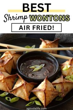 the best shrimp wontons air fried on a black plate with chopsticks