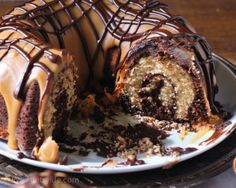 a bundt cake with chocolate icing and caramel drizzle