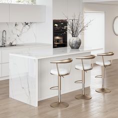 a white kitchen with marble counter tops and stools in front of the bar area