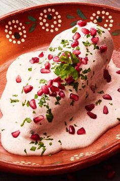 a plate with some kind of food on it and garnished with pomegranates