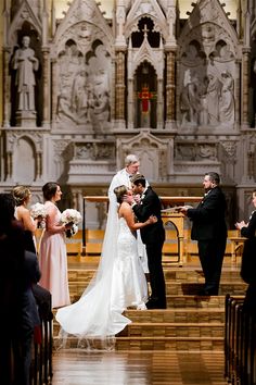 the bride and groom are getting married at the alter