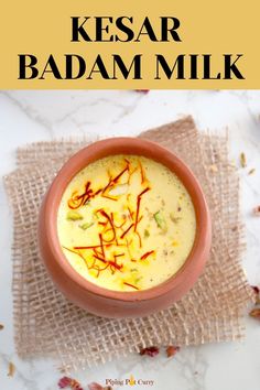 Badam Milk in a cup with saffron on top