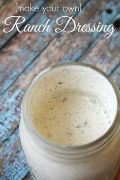 a mason jar filled with ranch dressing sitting on top of a wooden table