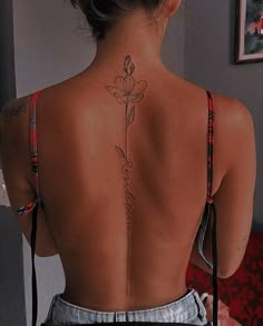 a woman with a flower tattoo on her back