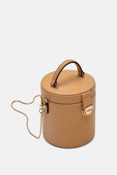 Luxury On-the-go Bags With Round Handle, Luxury Box-shaped Bag, Luxury Round Handle Bag For On-the-go, Luxury Shoulder Bag With Round Handle For On-the-go, Designer Bag With Gold-tone Hardware And Round Handle