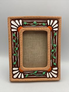 a brown and green frame sitting on top of a table