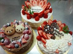 three cakes are decorated with fresh strawberries and teddy bears