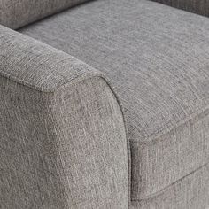 a close up view of the back end of a gray couch with buttons on it