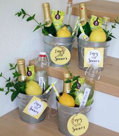 four buckets filled with lemonade and wine bottles