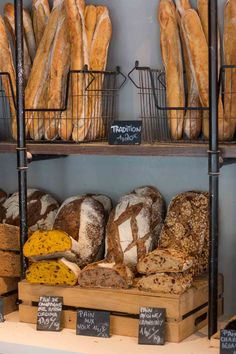 breads and other baked goods on display in a bakery