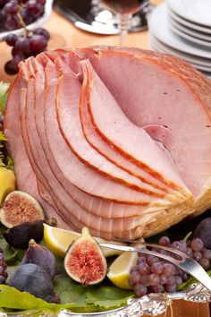 ham, figs and grapes on a platter with silverware