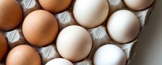 an egg tray filled with brown and white eggs