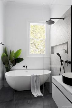 a white bath tub sitting next to a window