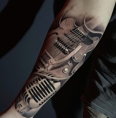 a man with a guitar tattoo on his arm