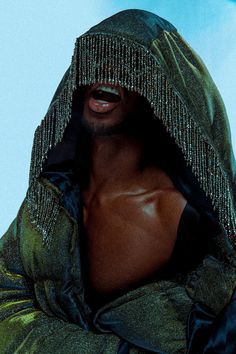 a man in a shiny jacket with his face covered by a hood and eyes closed